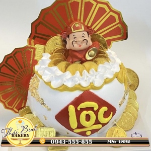 Bánh kem thần tài cầm thỏi vàng